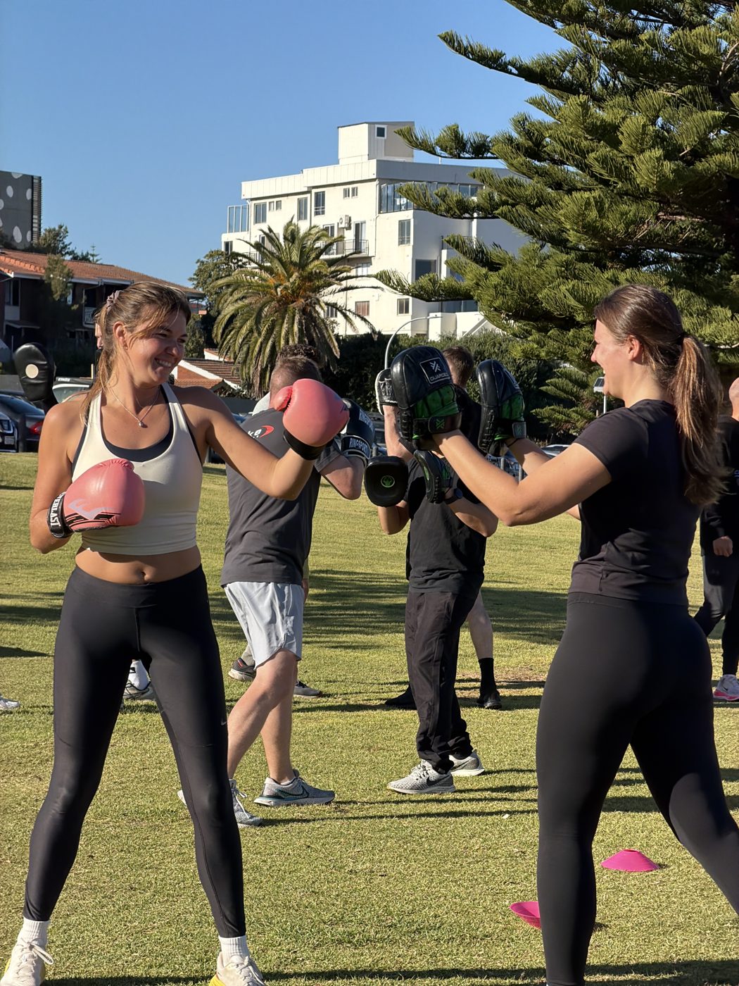 Boxing social pad work in the park