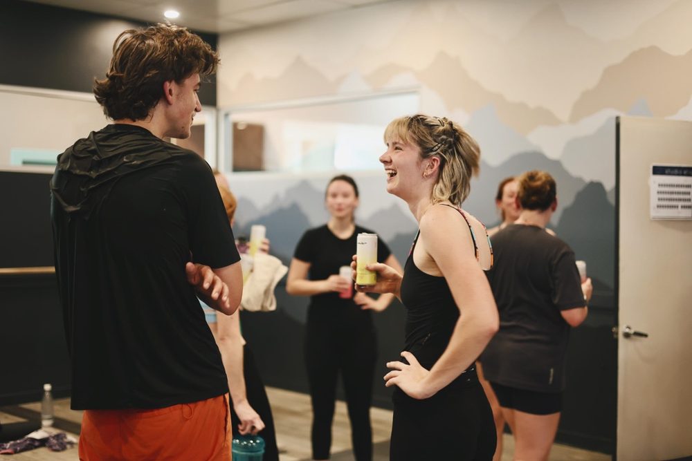 Newbies chatting and laughing after a hot yoga social