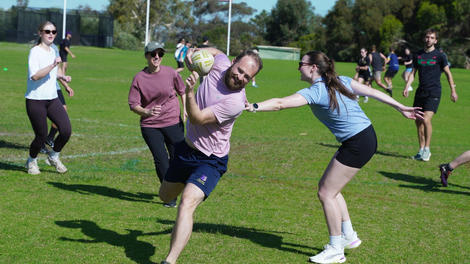 Newbie running with the ball at a field sports social