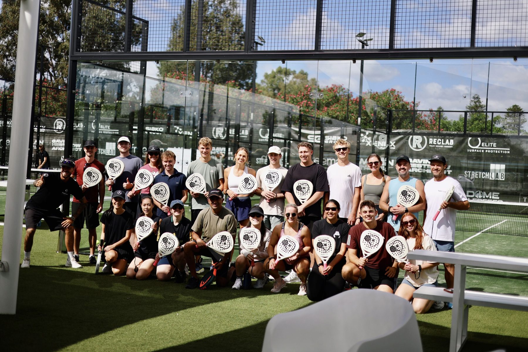 Padel social group photo with paddles