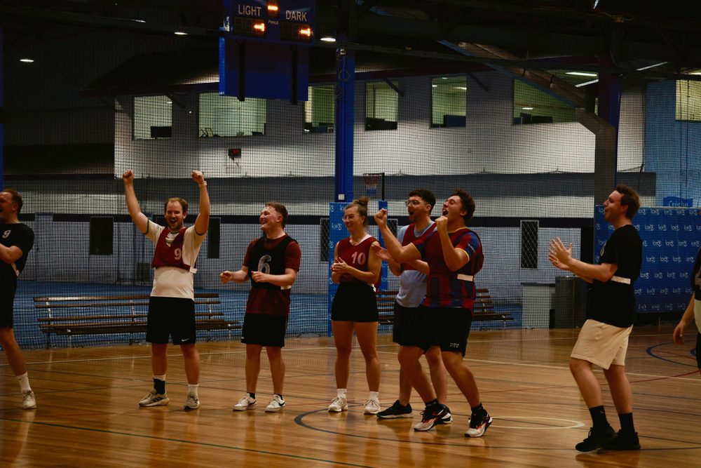 Newbies cheering on the court at an indoor soccer social